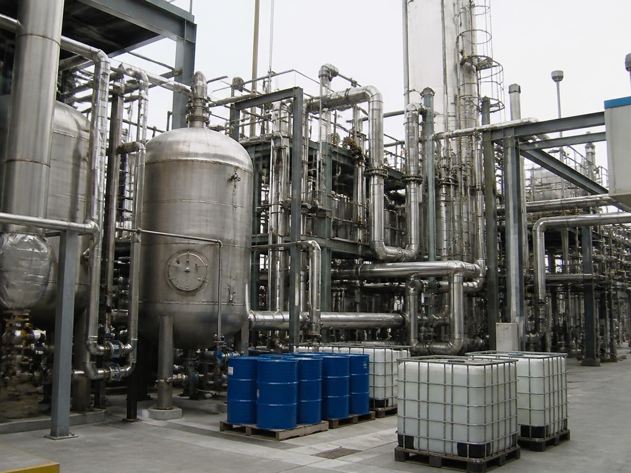 Stainless steel process vessels, pipework, drums and IBC totes at an industrial chemical plant